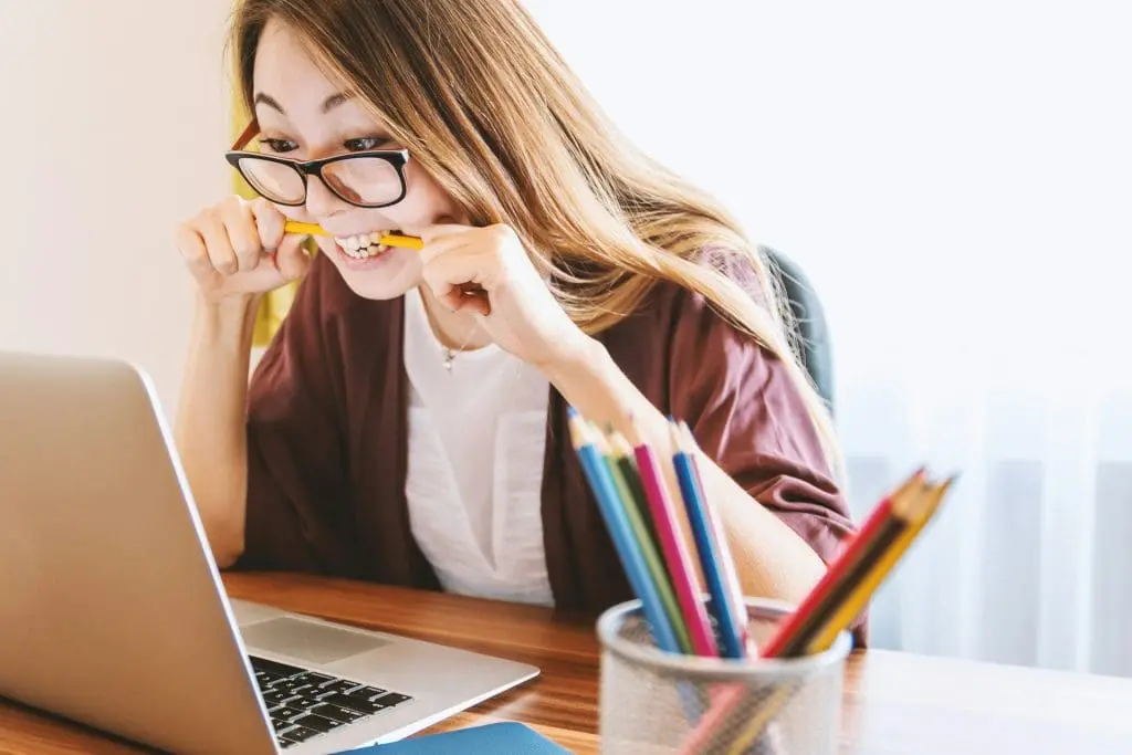 stressed woman chewing on pencil