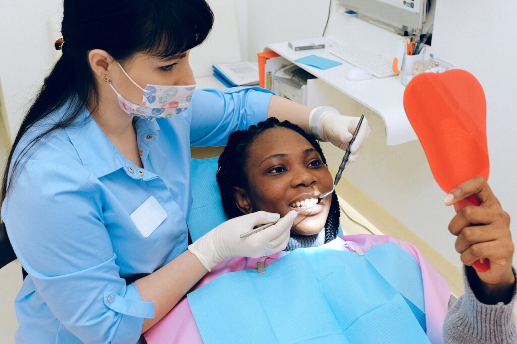 woman getting dental checkup from dentist