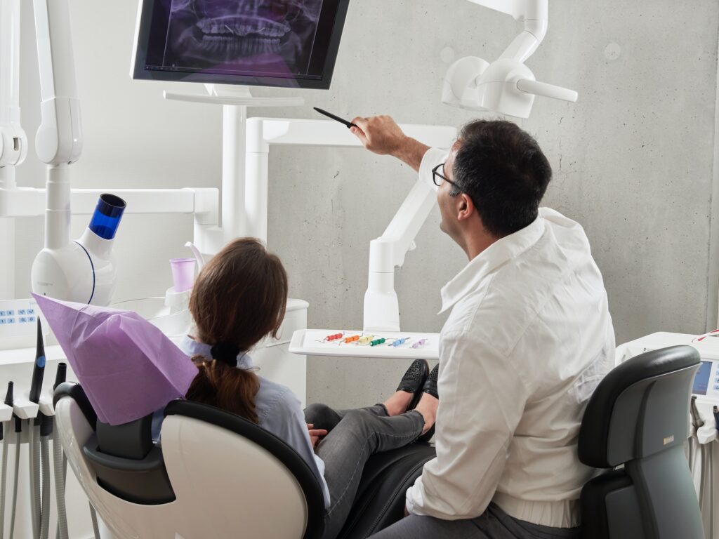 dentist explaining x-ray to female patient