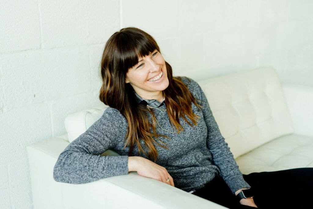 woman smiling sitting on couch
