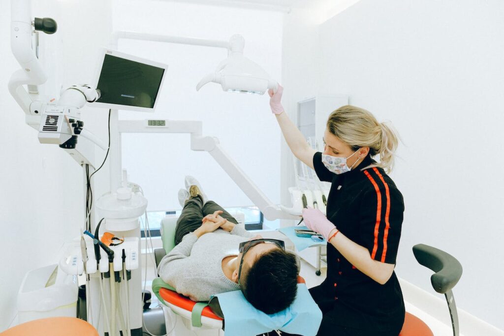 man getting dental treatment in dentist chair