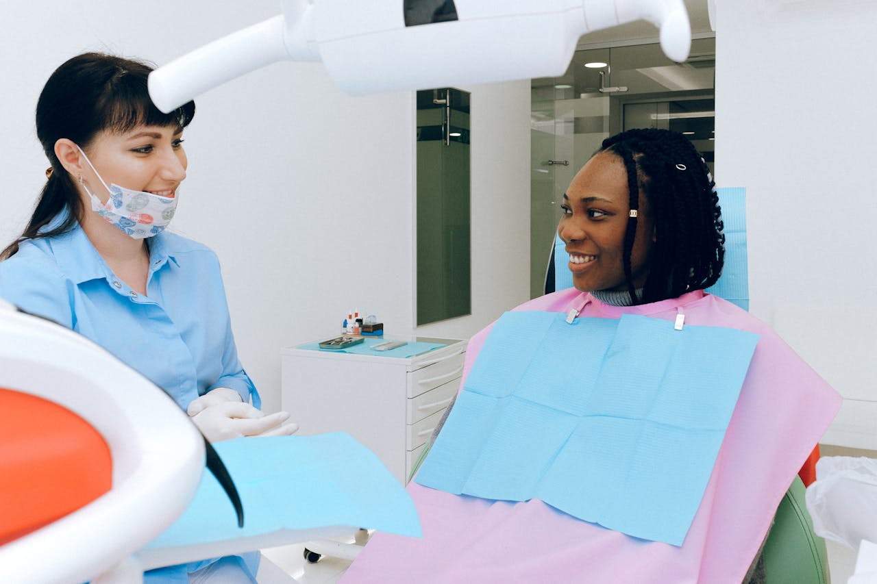patient smiling talking with dentist in dental office