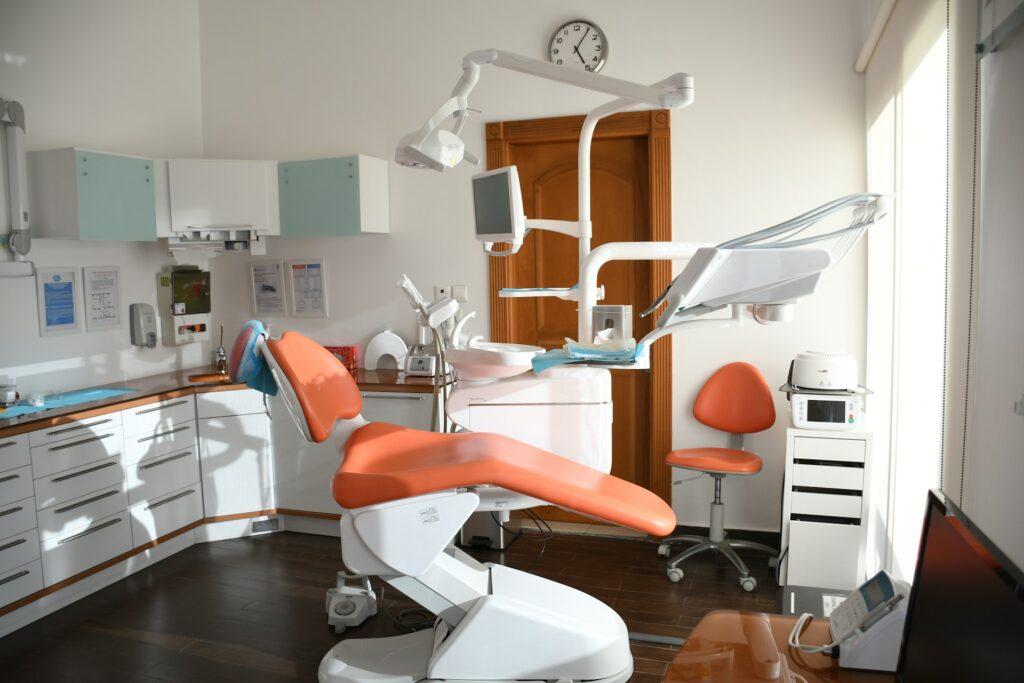 orange dentist chair in dental exam room