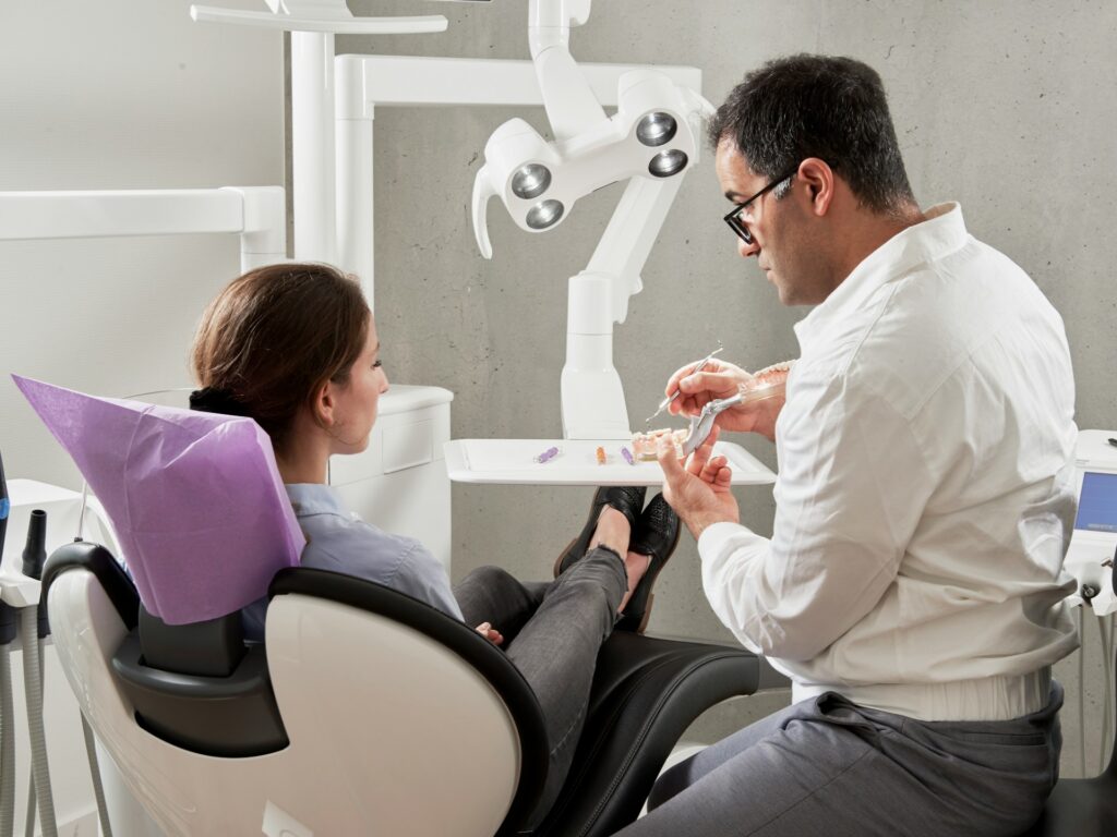 dentist talking to woman in dental office