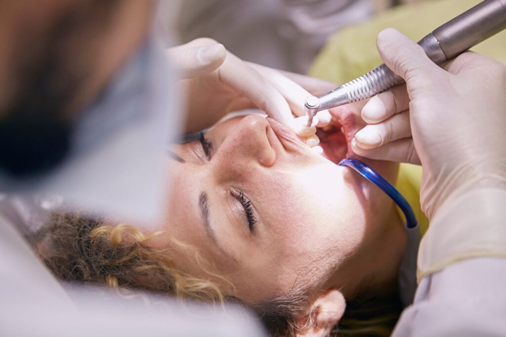 woman getting dental work with eyes closed