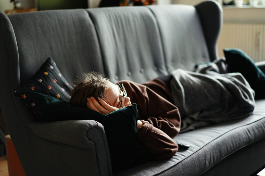 woman resting on dark gray couch